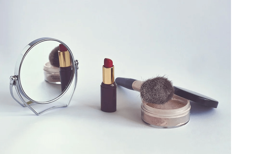 mirror, red lipstick, cosmetic brush, powder
