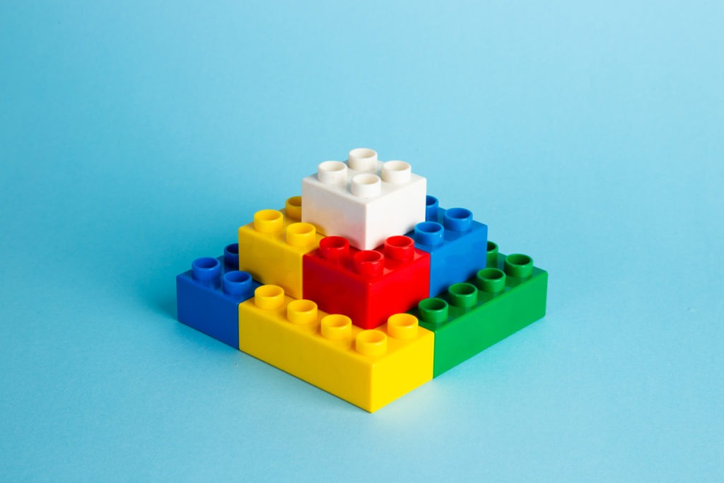 Lego puzzle plastic building blocks with blue background